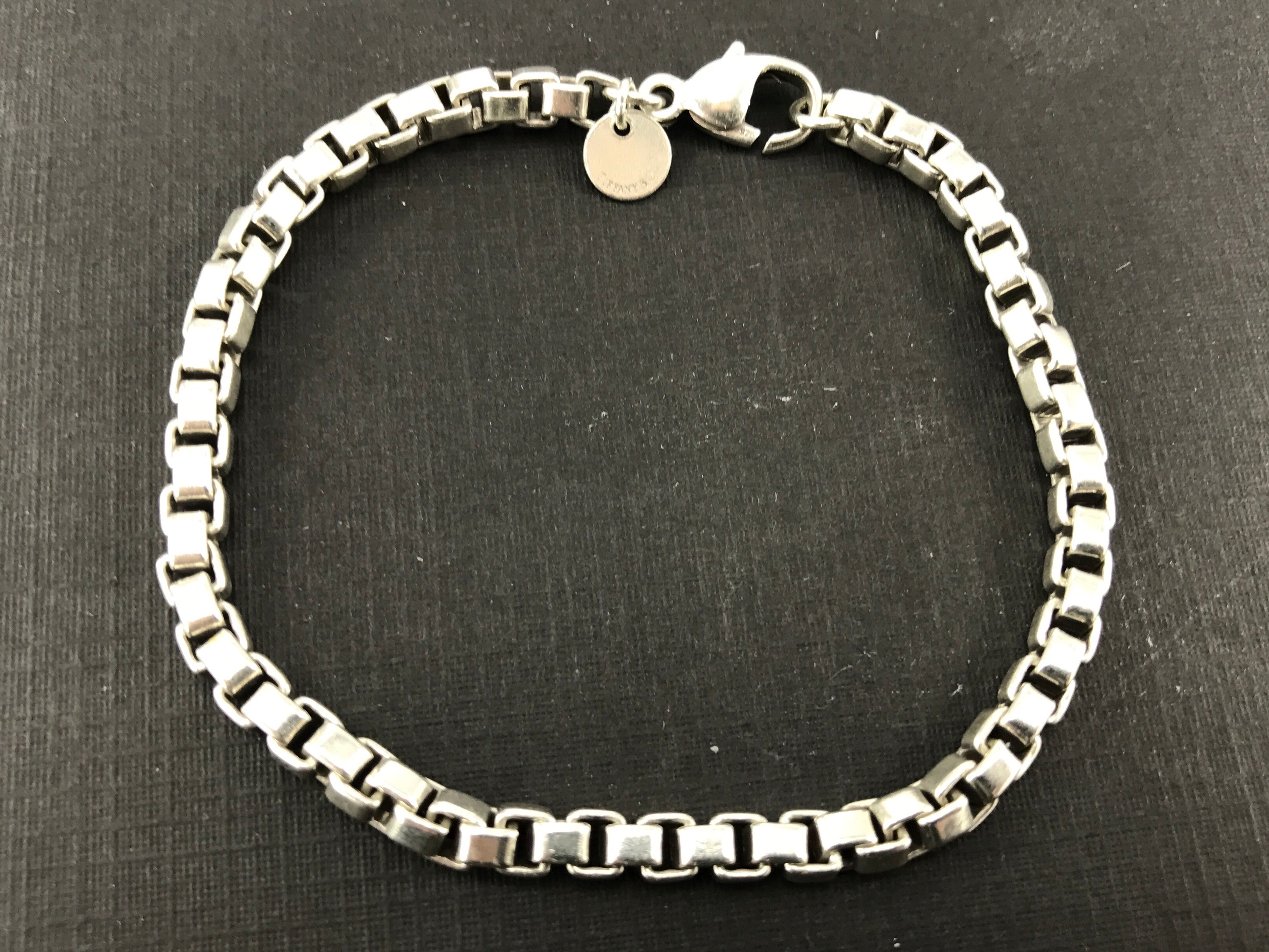 Silver chain link bracelet, hallmarked Tiffany and Co., London 2001, with  abstract heart shaped key